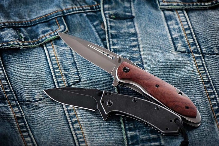 Two folding knives on denim