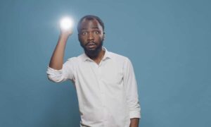 confused person using flashlight