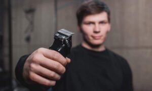 Guy holding electric clippers
