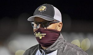 High school football coach with neck gaiter