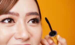 woman applying mascara