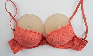Breast implants in an orange bra