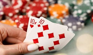 Female hand holding playing cards in casino