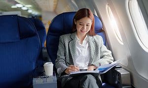 Woman writing on a plane