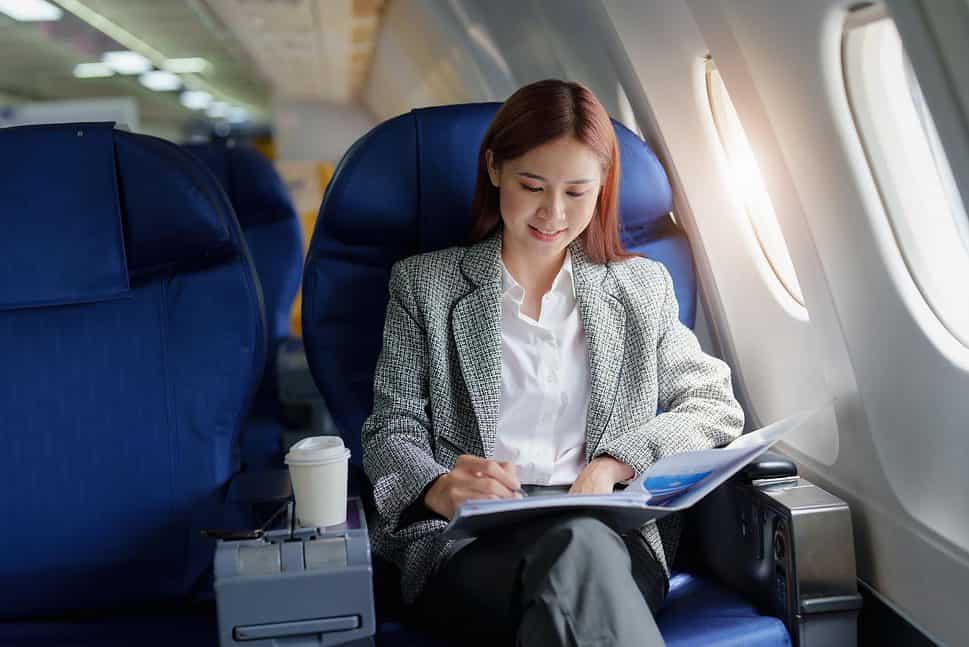 Woman writing on a plane