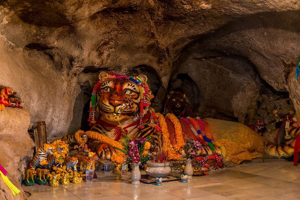 large tiger sculpture with religious attributes in a tiger cave in Krabi Thailand