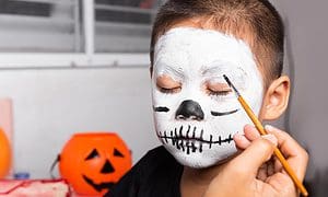 mother and child getting makeup halloween face painting