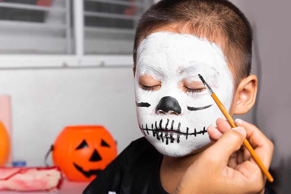mother and child getting makeup halloween face painting