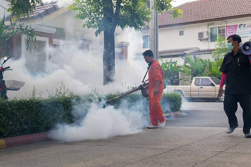People fogging DDT to control Malaria, Encephalitis, Dengue and Zika in a village in Bangkok, Thailand